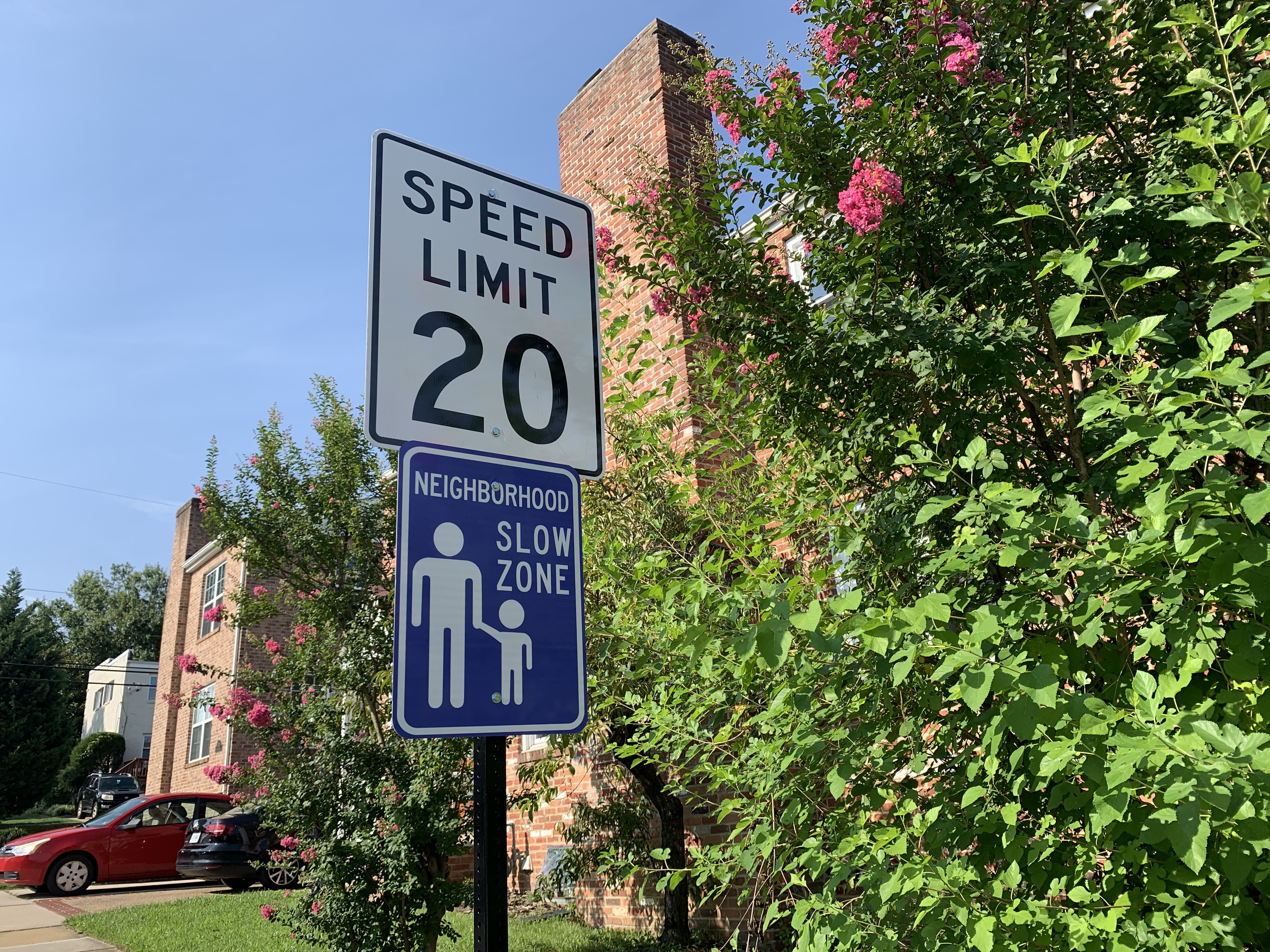 An image of a 20 MPH speed limit and neighborhood slow zone sign