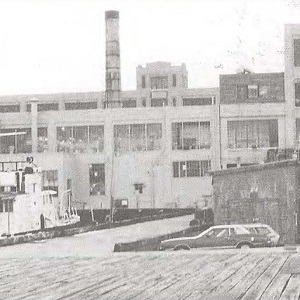 Alexandria Naval Torpedo Station with ferry and cars, black-and-white photograph