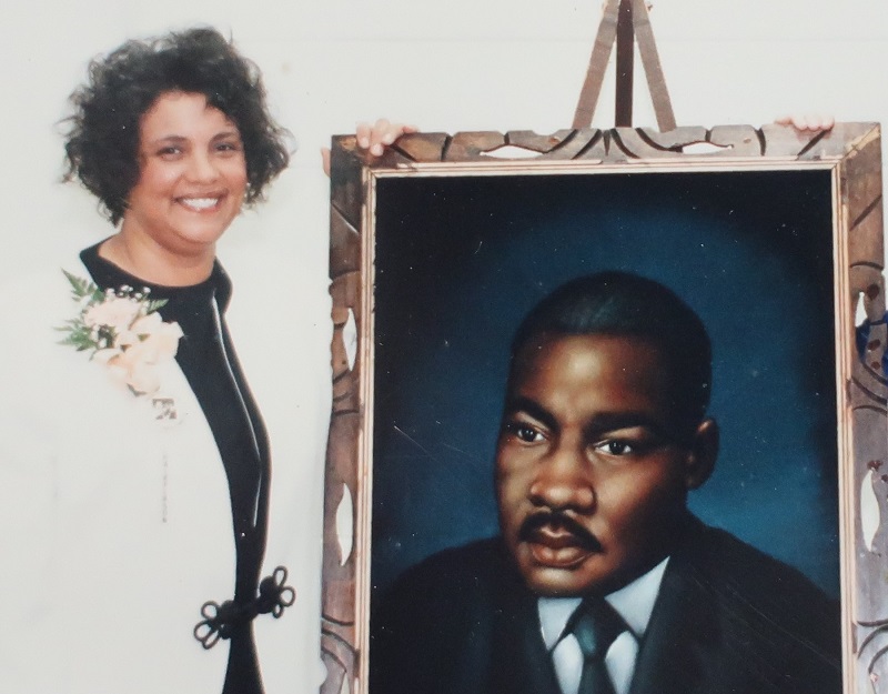 Alice Morgan with a portrait of Martin Luther King, Jr.