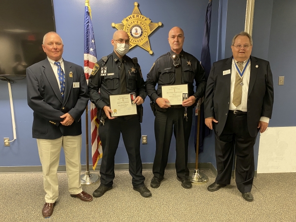 Two deputies receiving award from two community members