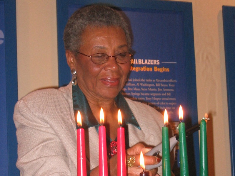 Lillian Patterson lights the Kwanzaa candles at the Alexandria Black History Museum, 2021