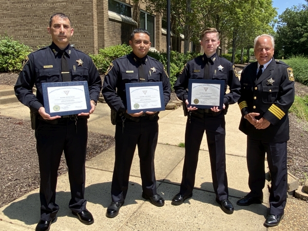 Sheriff and three deputies holding diplomas