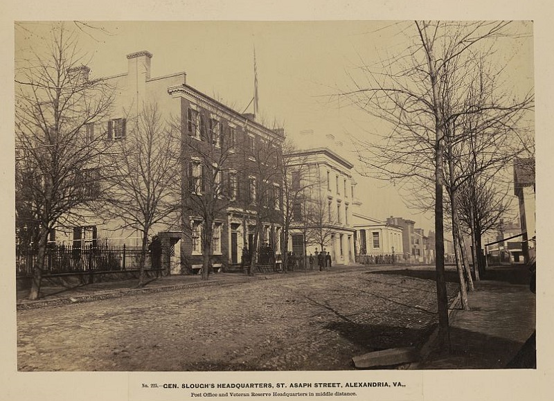 Gen. Slough's headquarters, St. Asaph Street, Alexandria, Va. Post office and veteran's reserve headquarters in middle distance. Second Presbyterian Hospital is in the distance, with the peaked roof.