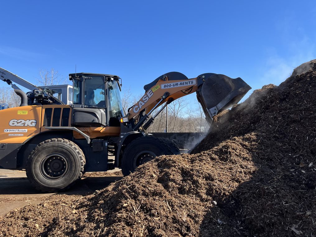 A vehicle loads in mulch at the City's mulch pickup lot on Eisenhower Ave.