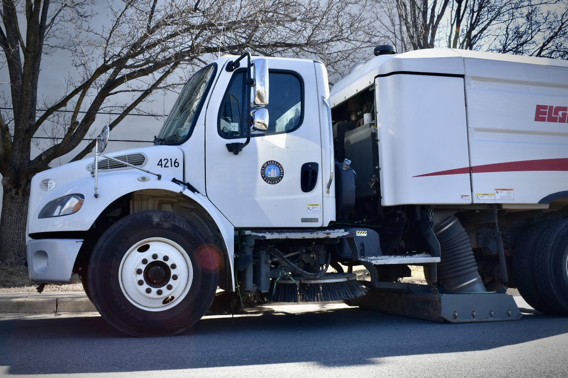 A side view of a street sweeper vehicle used by City street cleaning views