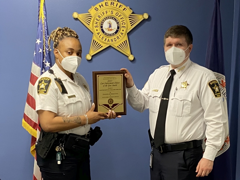 sergeant receiving plaque from sheriff