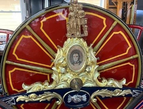 Hose Carriage Detail after conservation, 2022, with portrait and clasped hands