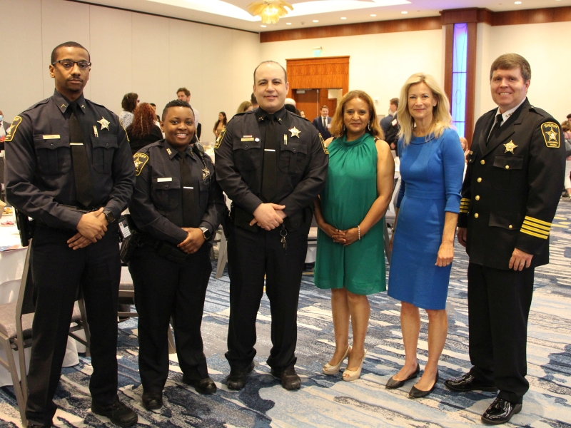 deputies and sheriff in uniform with two civilian women at event
