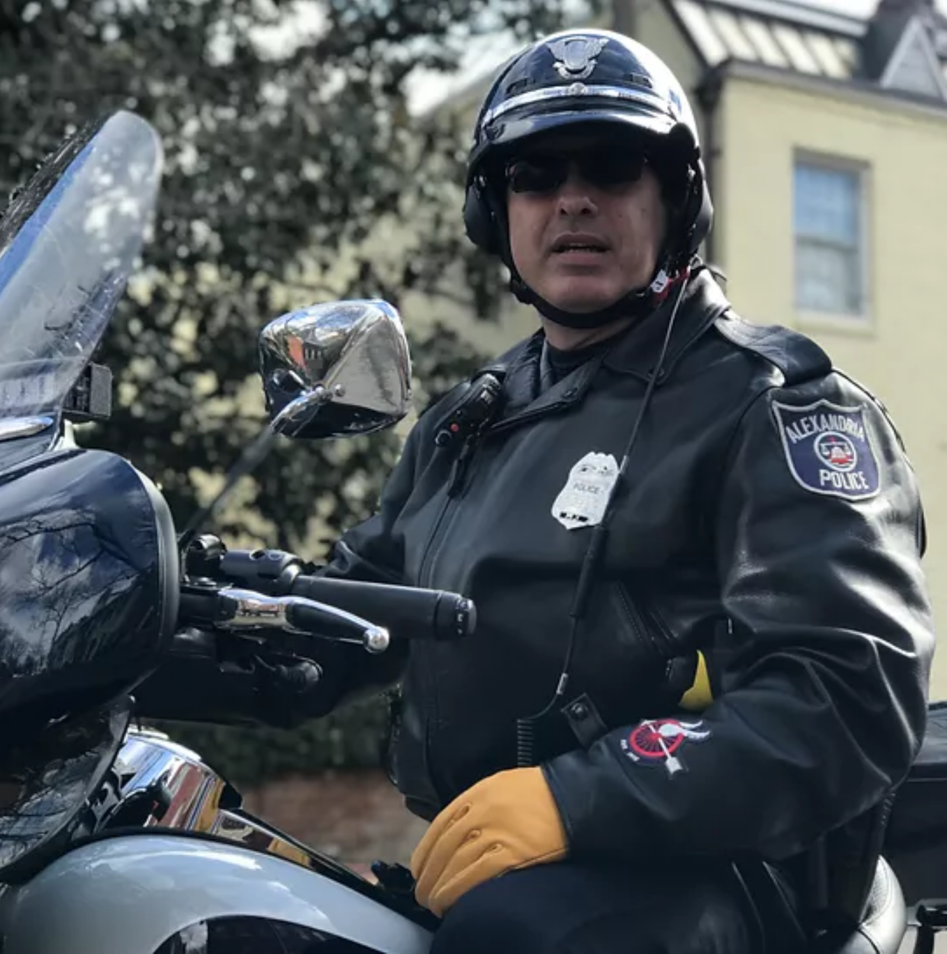 Trapero, wearing a motorcyle helmet and sunglasses, is sitting on his APD motorcycle.