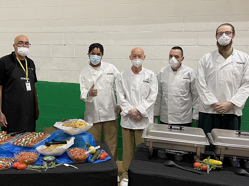 food service team with buffet of food in front