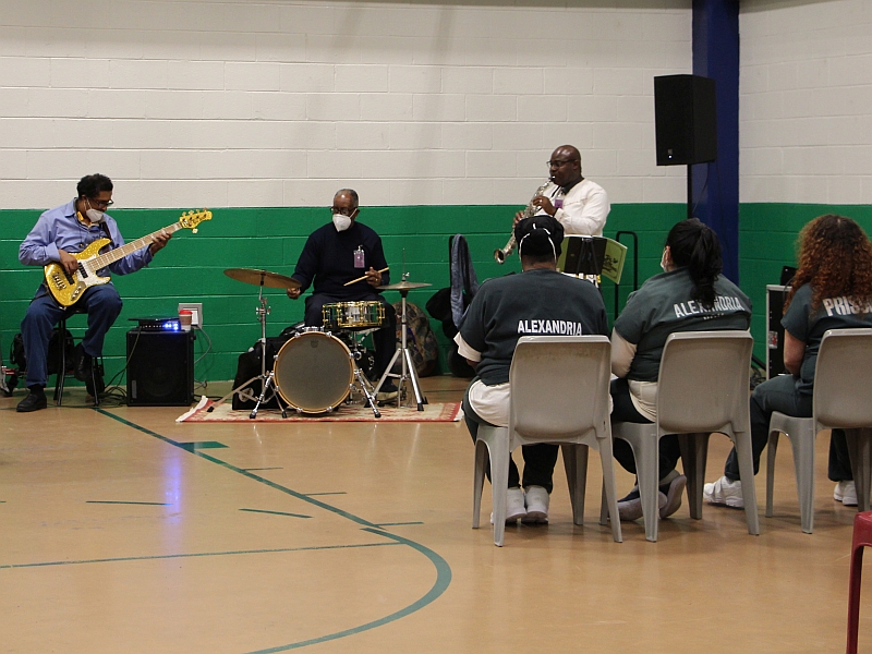 musicians performing with inmates watching