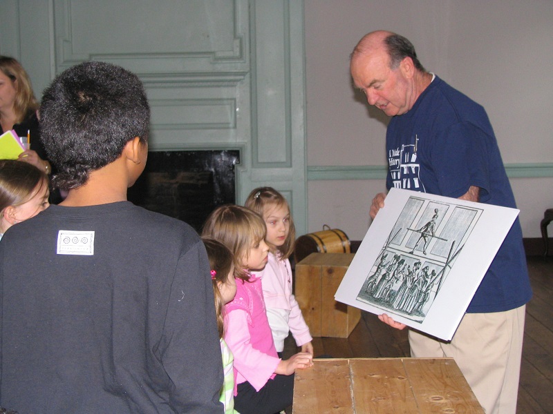 Hunt for History at Gadsby's Tavern. Docent shows image to children