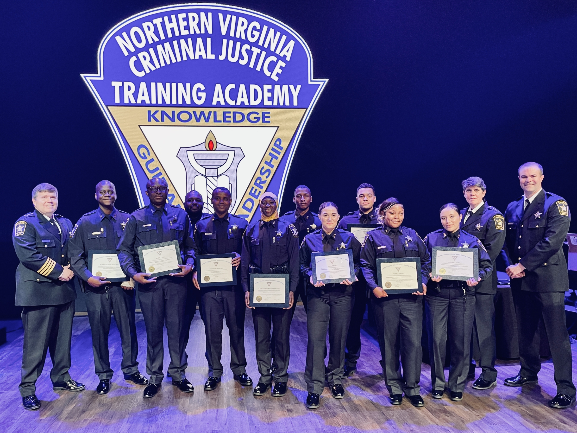 Thirteen uniformed personnel, including Sheriff and ten recruits holding certificates, in from a large logo reading Northern Virginia Criminal Justice Training Academy