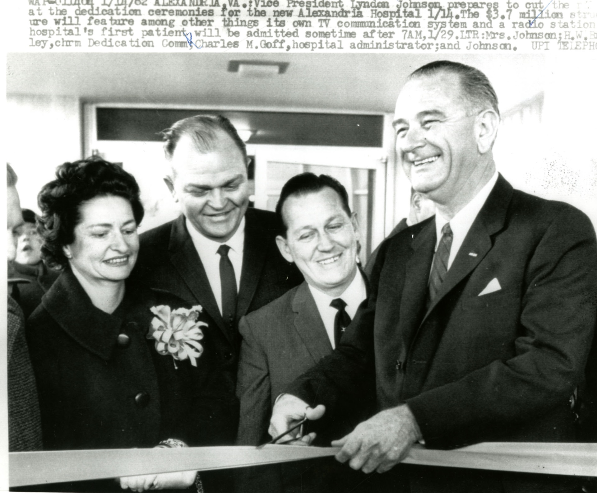 Lyndon Johnson and three others cutting ribbon