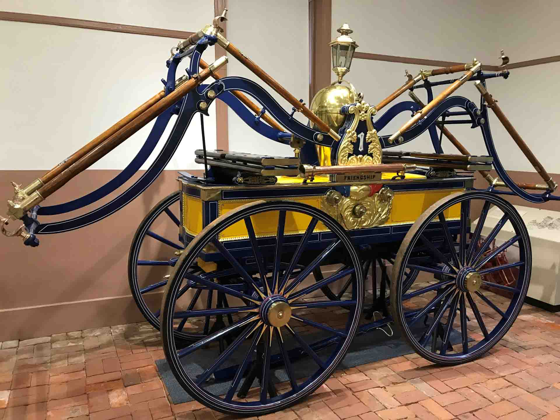 Newly restored pumper in museum, painted yellow and blue