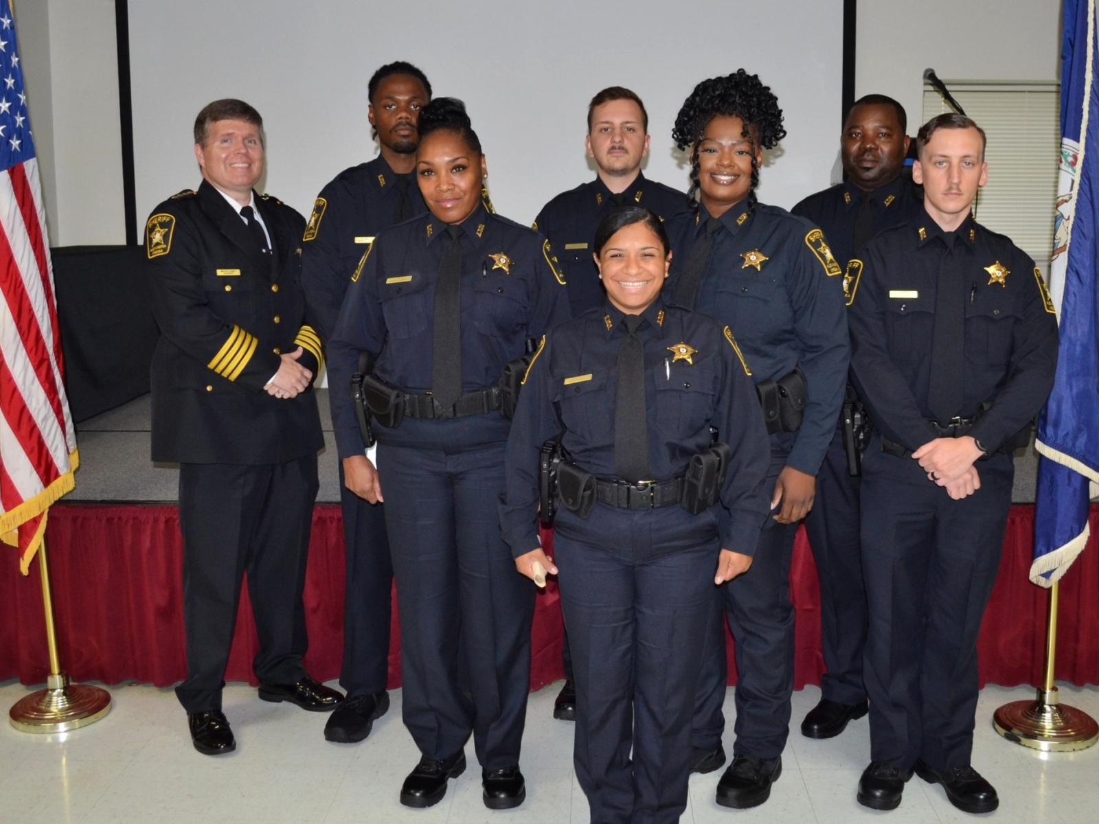 Sheriff and seven recruit deputies standing at academy graduation