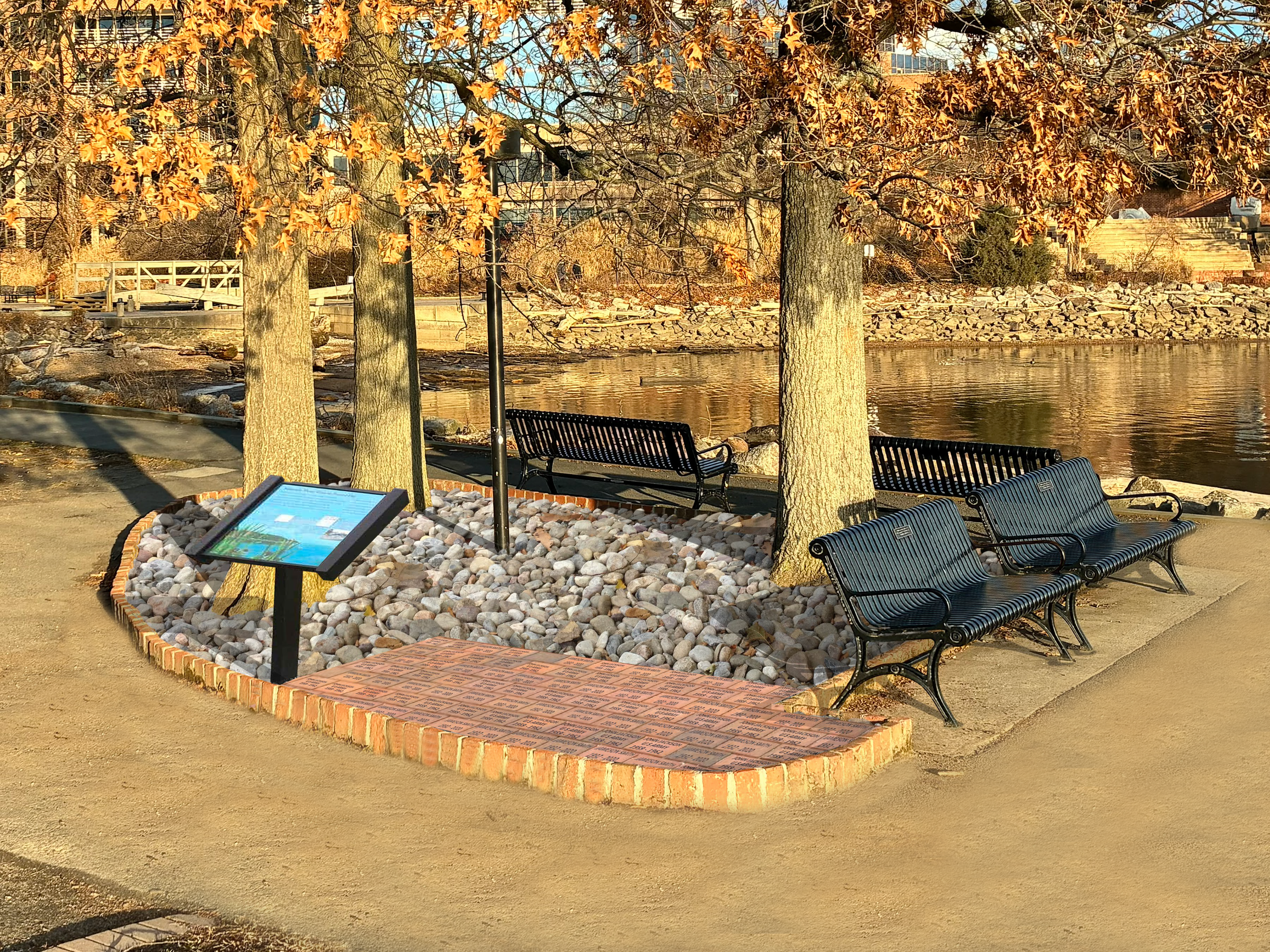 city park with benches, bricks and a sign