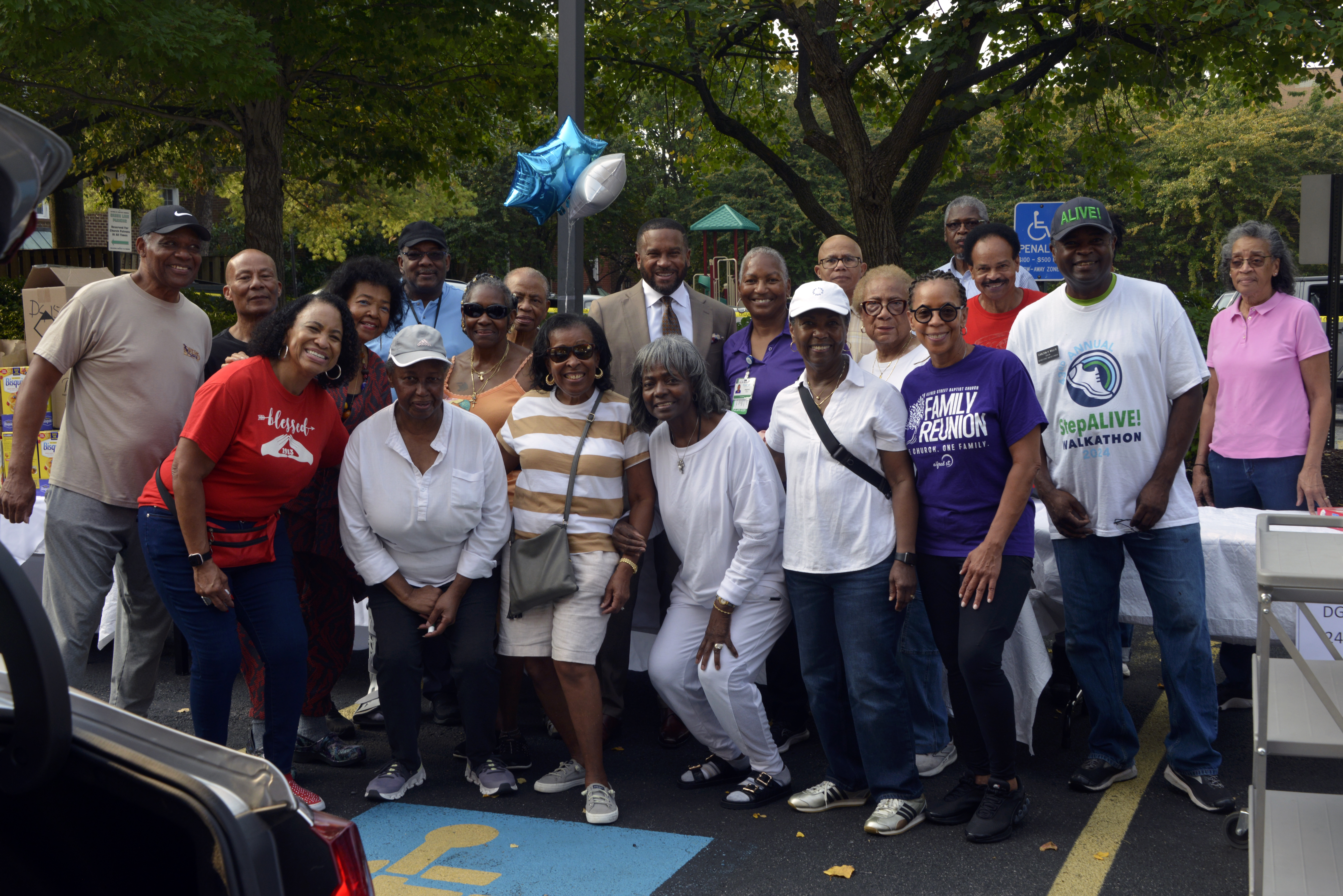 Group photo of Alfred St Baptist Church volunteers who helped organize and collect food during a Faith & Blue Weekend food drive in 2025.