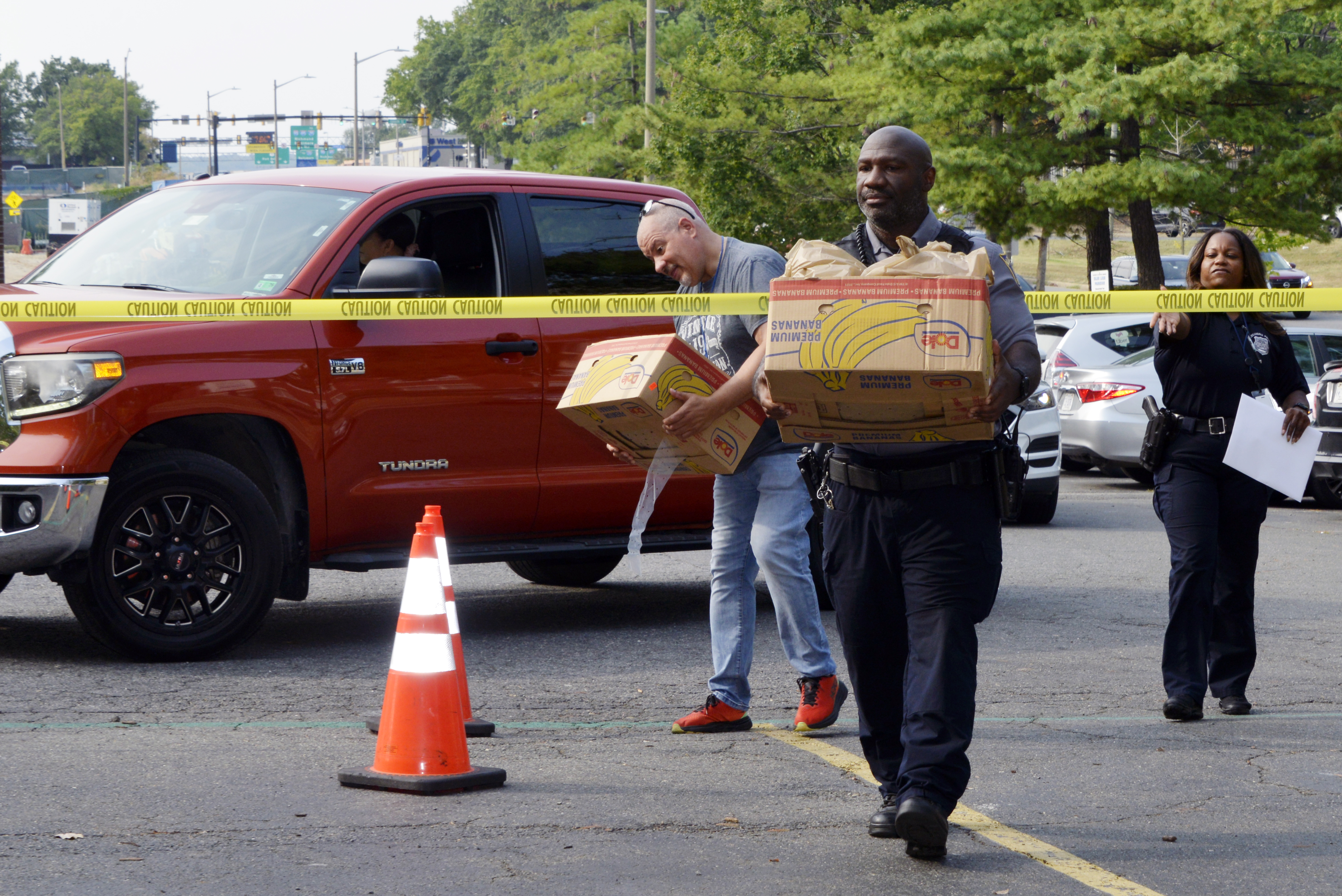 Officers collect food as part of a Faith & Blue Food drive in 2025.