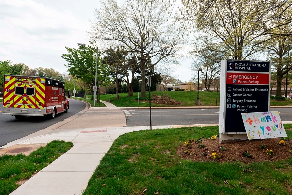 Entrance to Inova Hospital in Alexandria, an ambulance is driving by.
