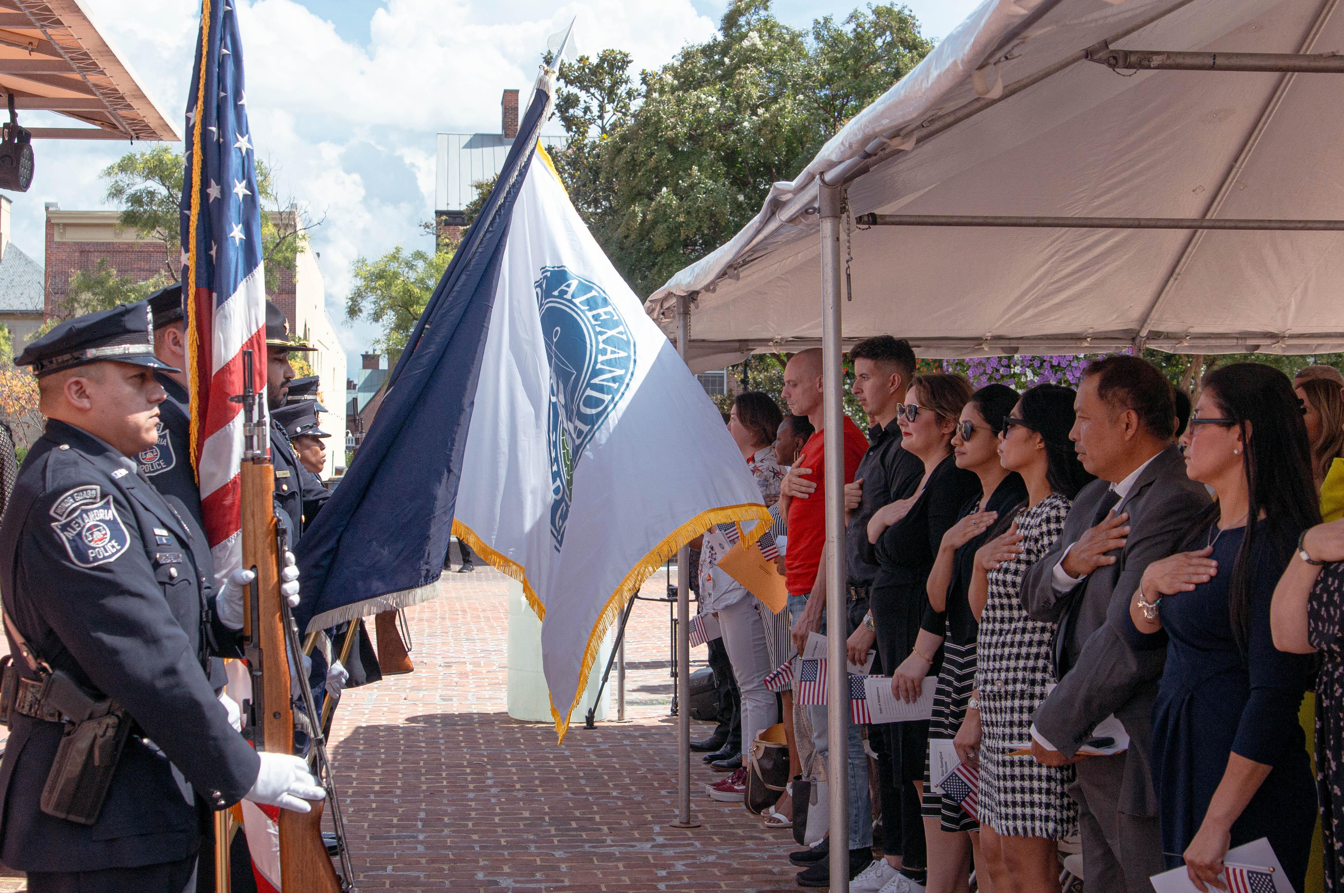 25 new United States citizens taking their Oath of Allegiance on Tuesday, September 12, in Market Square outside of Alexandria City Hall
