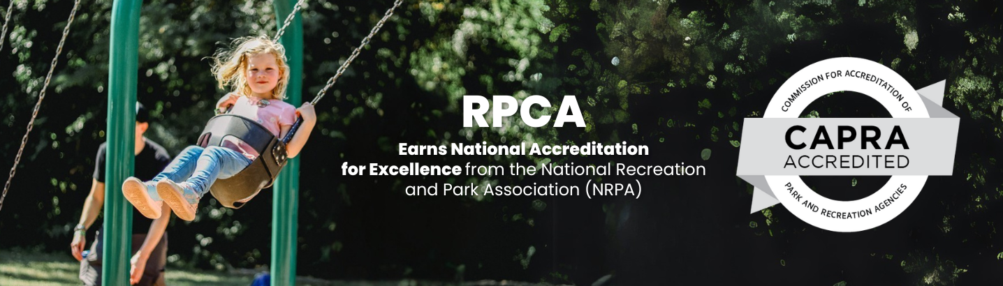 girl in a baby swing with the CAPRA logo on the far right and the words RPCA earns excellence and accreditation in the center