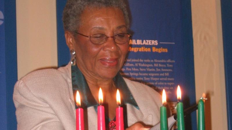 Lillian Patterson lights the Kwanzaa candles at the Alexandria Black History Museum, 2021