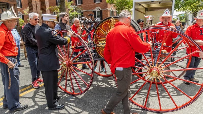 FVFEA members and Fire Chief Corey Smedley help to move the hose reel
