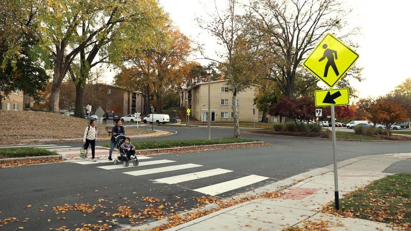 A photo of a family crossing Reading Avenue using the new crosswalk.