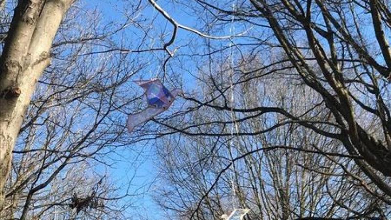stained glass origami birds hanging in a tree