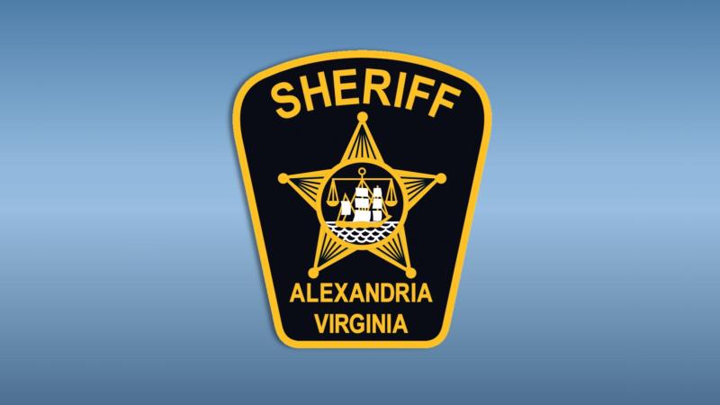 Design of shoulder patch, dark blue field with gold trim, gold lettering reading Sheriff and Alexandria Virginia, with gold star and city seal of ship and scales in the center