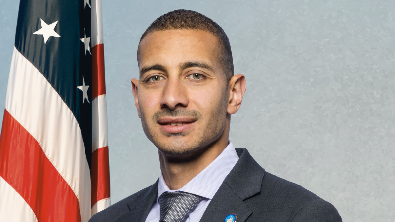 councilman elnoubi on blue background with american flag