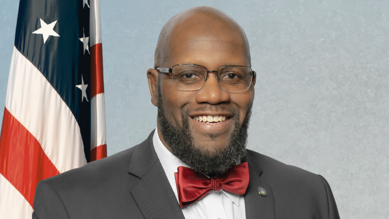 councilman chapman on blue background with american flag
