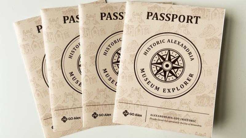 tan covers of four museum passports