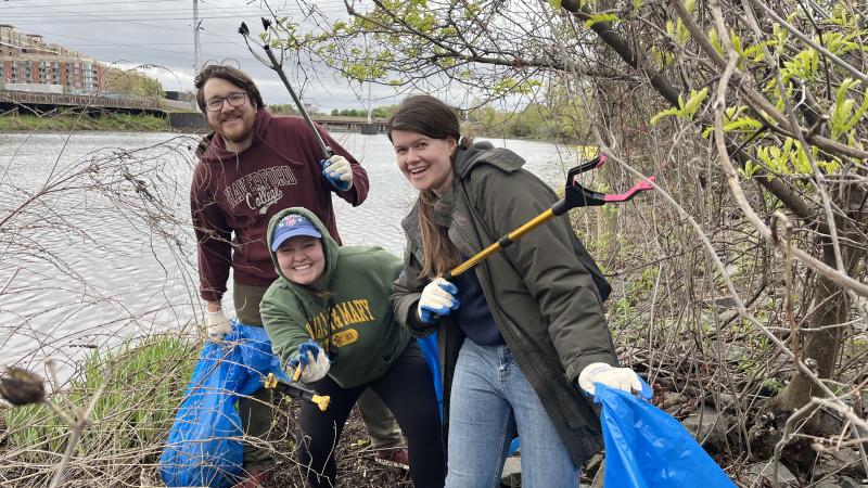 Volunteers pose with their bags and grabbers at the Four Mile Run steam cleanup.