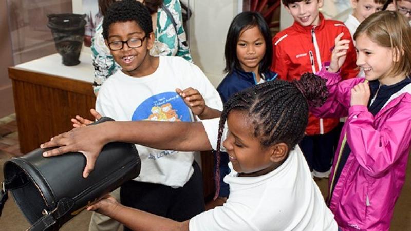 A group of elementary-aged children engaging in a program at one of Historic Alexandria's museums. 
