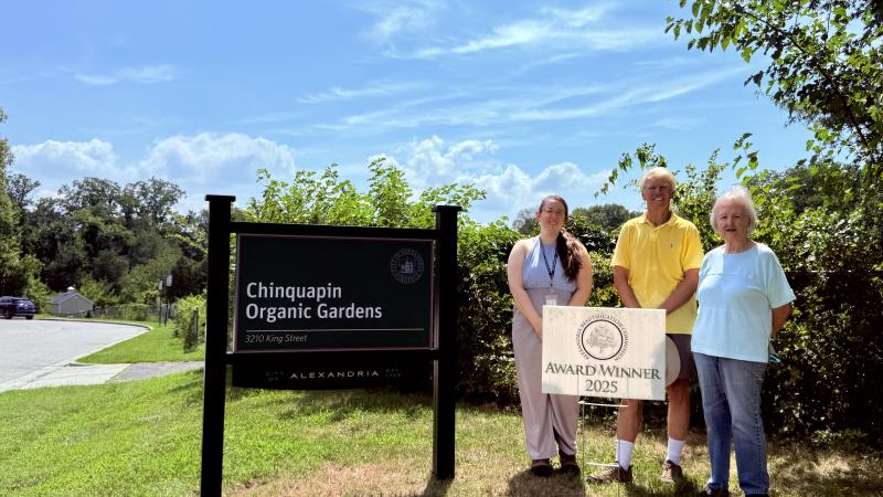 Chinquapin Organic Garden sign on the left and the winners of the Beautification Community Category on the right