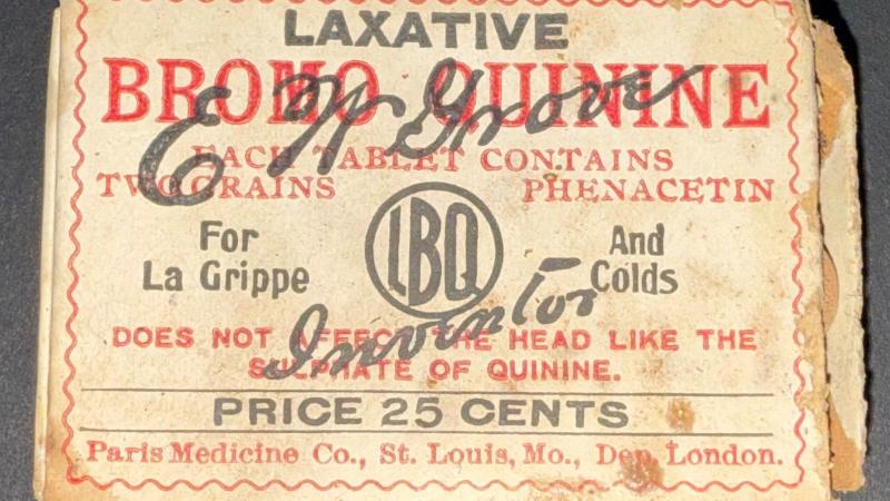 Small 2.5 by  1.5" yellow-ish box that reads "Laxative Bromo Quinine each tablet contains two grains phenacetin. For La Grippe and Colds. Does not effect the head like the sulphate of quinine. Price 25 cents. Paris Medicine Co., St. Louis, Mo. Dep. London. Box contains small round brown tablets.