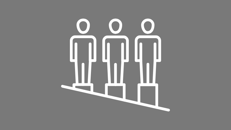 Icon of three human figures standing on blocks of different heights on a slanted surface