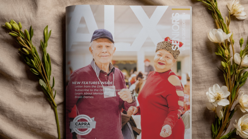 Image of the Senior Guide laying on a wheat linen with flowers and stems on each side