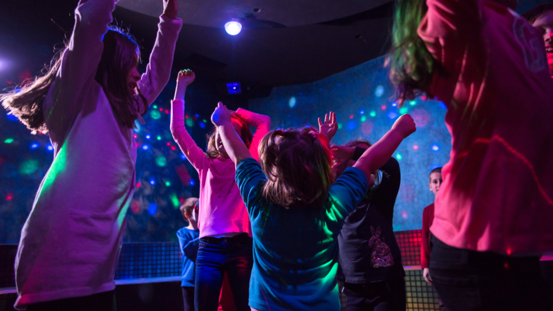 Kids dancing in the dark with glow lights