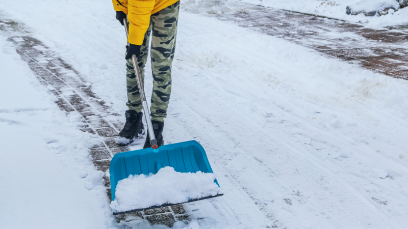 person with shovel and snow