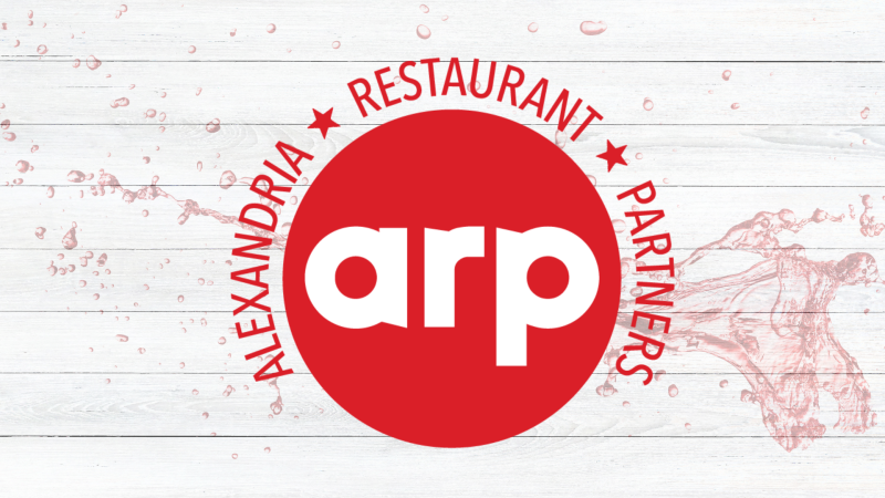 Alexandria Restaurant Partners logo in white and red centered on a light wood background with water splash graphics surrounding the design.