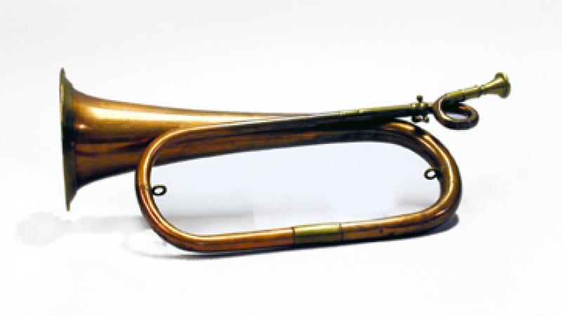 Copper bugle with a loop on the brass mouthpiece.