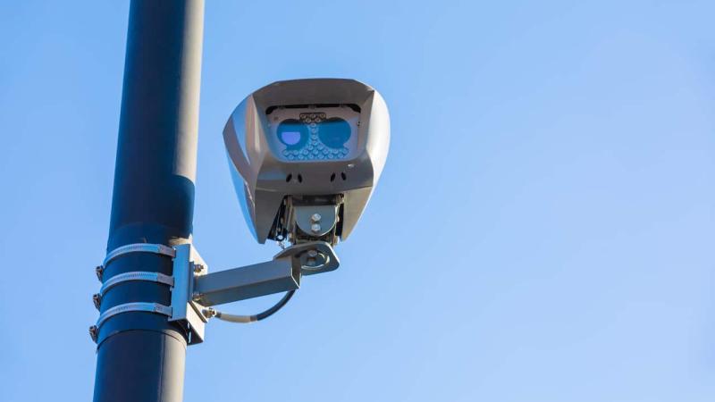 Camera mounted on the side of a light pole