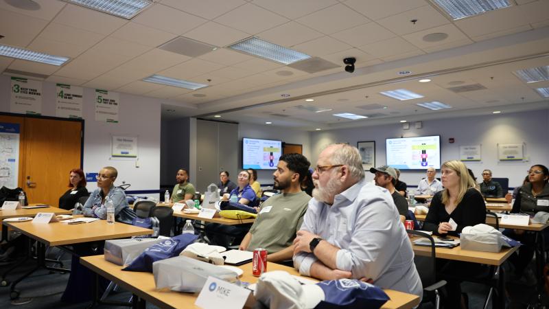 Photo showing City Academy participants listening to a presenter.