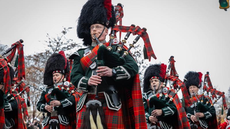 group in scottish garb playing bagpipes