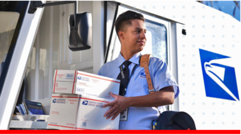 Postal worker in uniform carries USPS packages from a delivery truck, conveying reliable service and an efficient, professional tone.