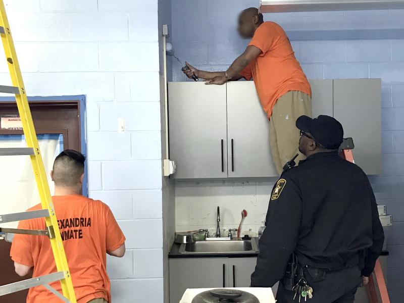 deputy overseeing inmates painting walls