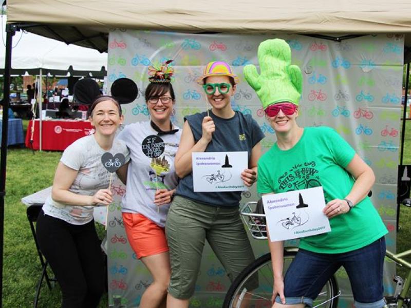 A photo of members of the Alexandria Spokeswomen bicycle group at Alexandria Earth Day